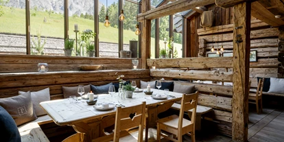 Hüttendorf - Sauna: im Hauptgebäude - Kellau - Restaurant Huwi's Alm mit Panoramafenster - PRIESTEREGG Premium ECO Resort