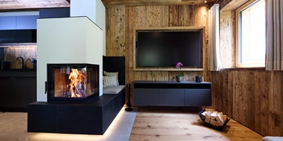 Hüttendorf - Parkplatz direkt an der Hütte - Wohnbereich mit TV - 5-Sterne Chalet Waldblick