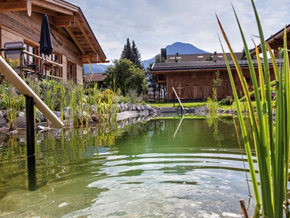 Hüttendorf - Schröcken - Freut euch nach erlebnisreichen Berg-Wanderungen auf unseren erfrischenden Natur-Schwimmteich  - Alpglück Chalets *****