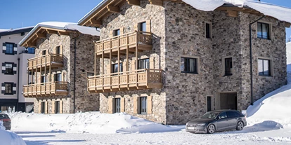 Hüttendorf - Weng (Goldegg) - Außenansicht Chalets im Winter - Kauz - Design Chalets