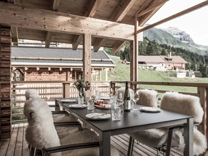 Hüttendorf - Schröcken - überdachter Außemsitzplatz mit Möbeln, Fellen, Laternen... - Aadla Walser-Chalets am Arlberg